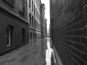 Empty alley amidst buildings in city