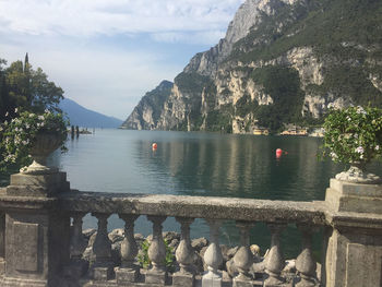 Scenic view of river by mountains against sky