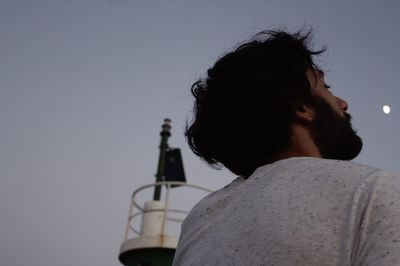 Rear view of a man against sky