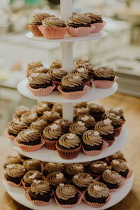 Close-up of cupcakes on cakestand at table