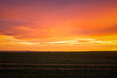 Scenic view of field against sky during sunset