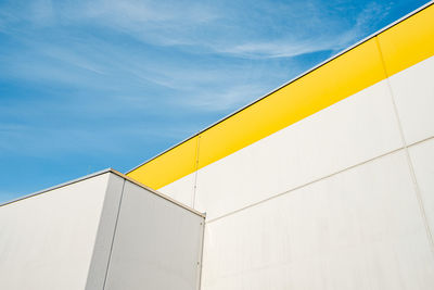 Low angle view of yellow building against sky