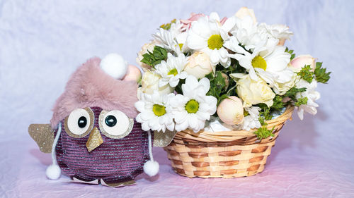 Close-up of flowers in basket on table