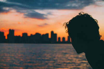 Close-up of silhouette of man against sky during sunset