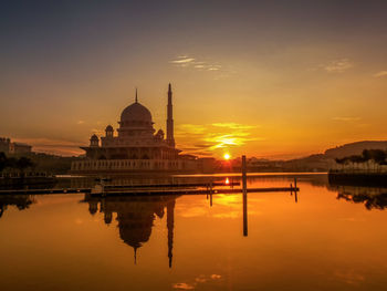 Reflection of mosque in lake during sunset