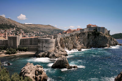 View of sea with buildings in background