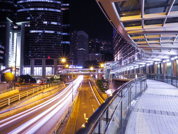 Light trails on illuminated street in city at night