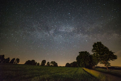 Scenic view of field against sky at night