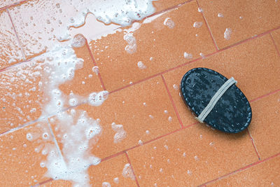 High angle view of wet shoes on floor