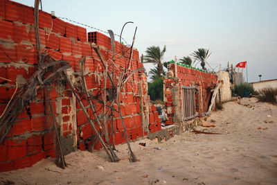 Damaged building on beach against sky