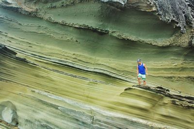 Rear view of a woman walking on shore