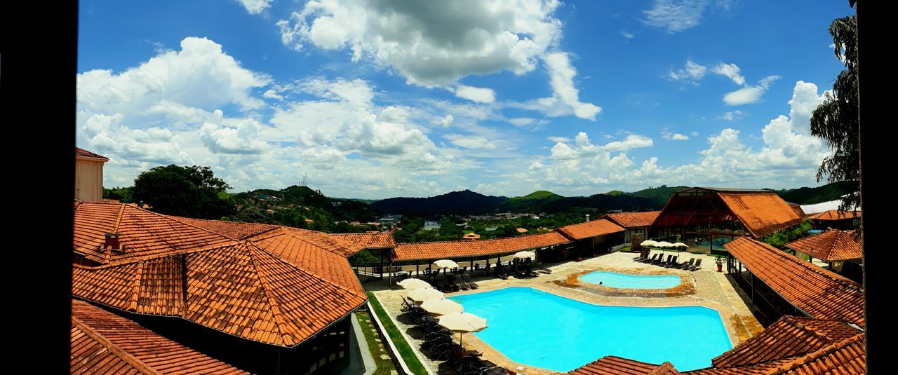 cloud - sky, architecture, sky, building exterior, built structure, nature, no people, building, high angle view, roof, water, day, residential district, tree, house, plant, outdoors, travel destinations, pool, swimming pool, roof tile