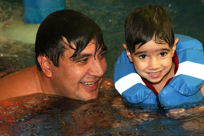 Portrait of smiling boy with reflection in water