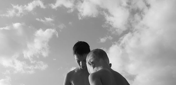 Rear view of couple against sky