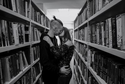 Full length of young man standing in library