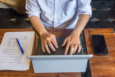 Midsection of man working at table