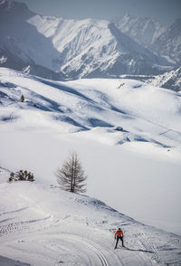 High angle view of woman skiing on snowcapped mountain