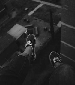 Low section of man dangling feet