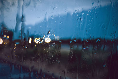 Full frame shot of wet glass window in rainy season