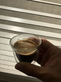 Close-up of hand holding coffee cup