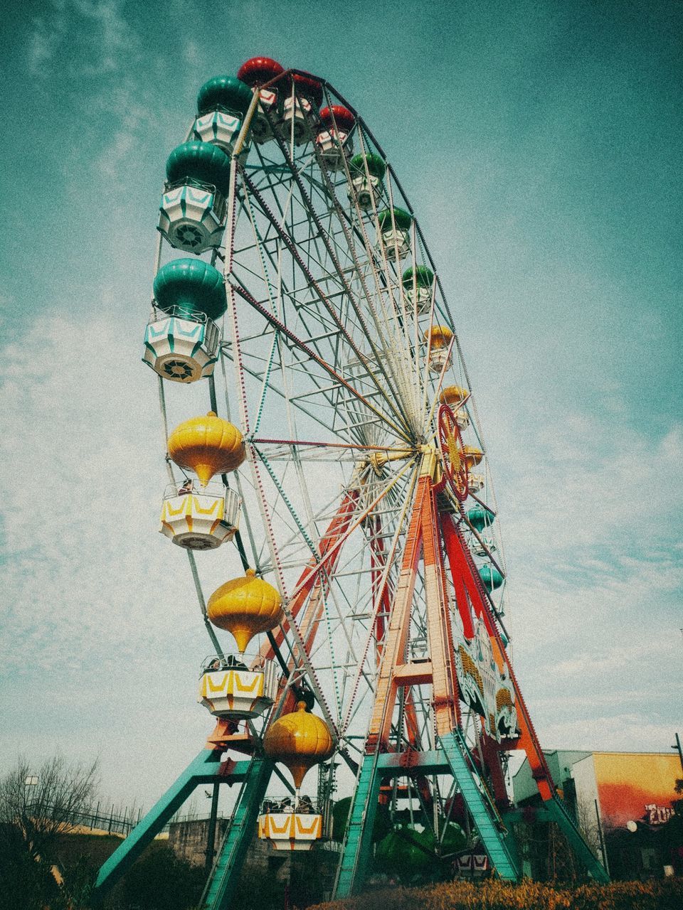 amusement park ride, amusement park, arts culture and entertainment, ferris wheel, sky, low angle view, nature, fairground, cloud - sky, day, no people, large, built structure, architecture, outdoors, geometric shape, circle, leisure activity, shape, absence