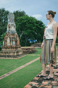 Full length of young woman standing on temple