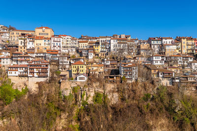 Buildings in town against clear blue sky