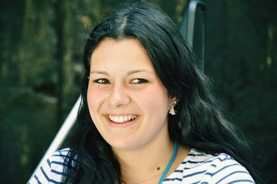 Close-up of smiling young woman looking away