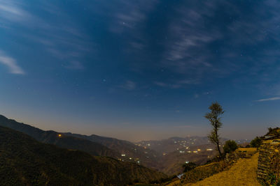 Scenic view of mountains against sky at night