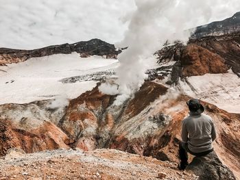 Rear view of person on rock