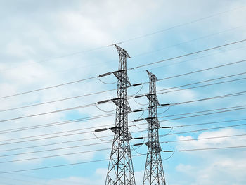 Low angle view of electricity pylon against sky