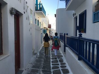 Rear view of women walking on street