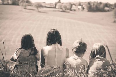 Rear view of children on field