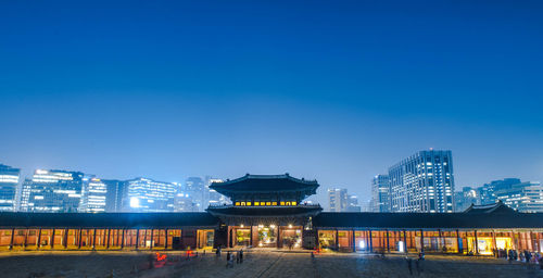 Illuminated buildings in city at night