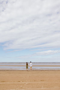 Couple of a man and a woman on a date on the beach by the sea.  walk picnic of two lovers in nature