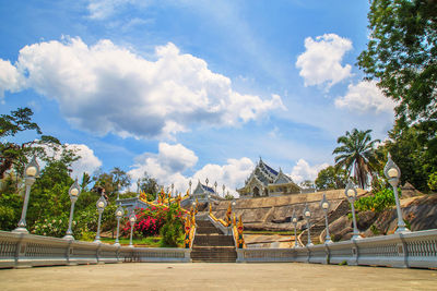 View of trees and plants against cloudy sky