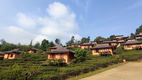 Houses on field against sky