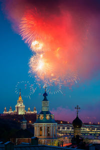 Firework display in city at night