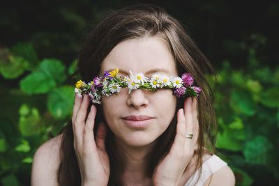 Portrait of woman with pink flower wreath