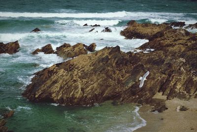 Rocks in sea against sky