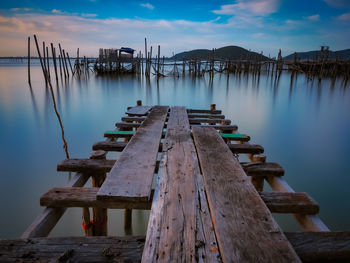 Pier over lake against sky