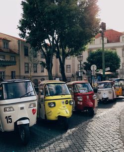 Jinrikishas parked by road against buildings