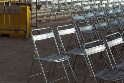 Empty chairs and tables in row