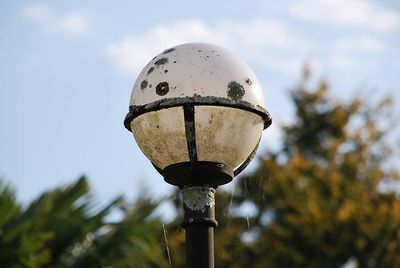 Low angle view of lighting equipment on street against sky