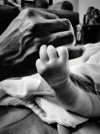 Close-up of hands on bed