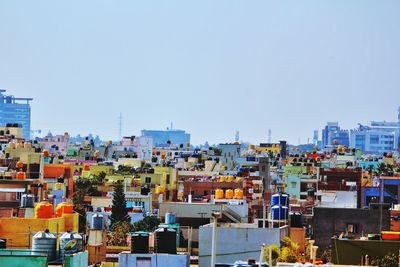 High angle view of buildings against clear blue sky