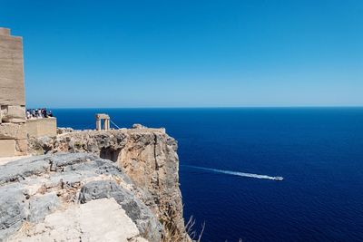 Scenic view of sea against clear blue sky