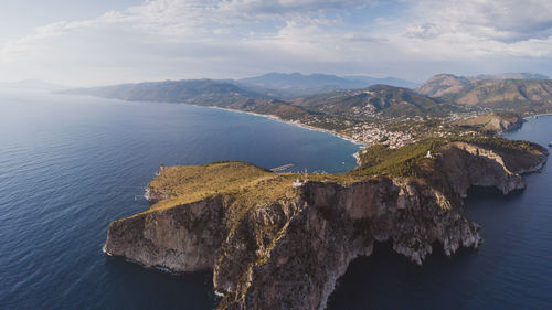 High angle view of rocks by sea against sky