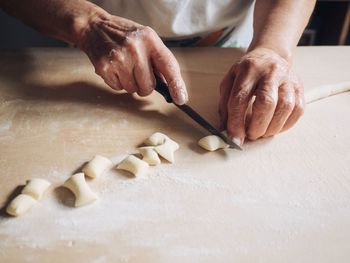 Midsection of man preparing food on table