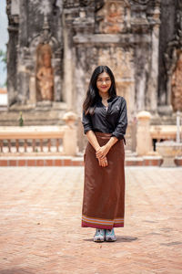 Young woman standing at temple